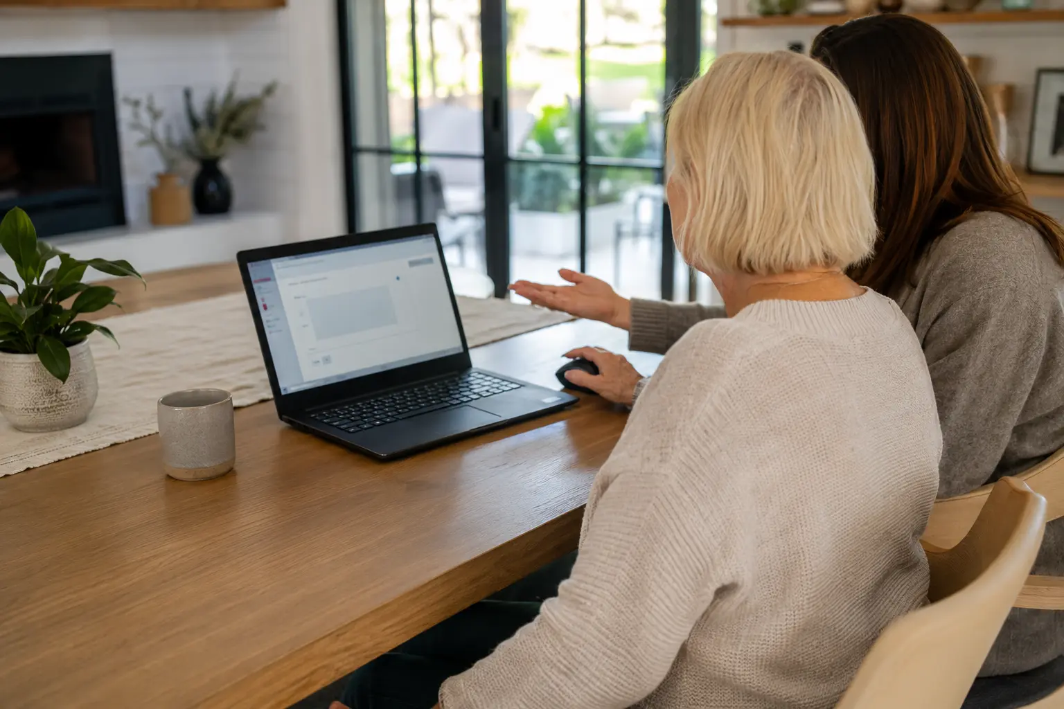 Two adults learning together at a laptop